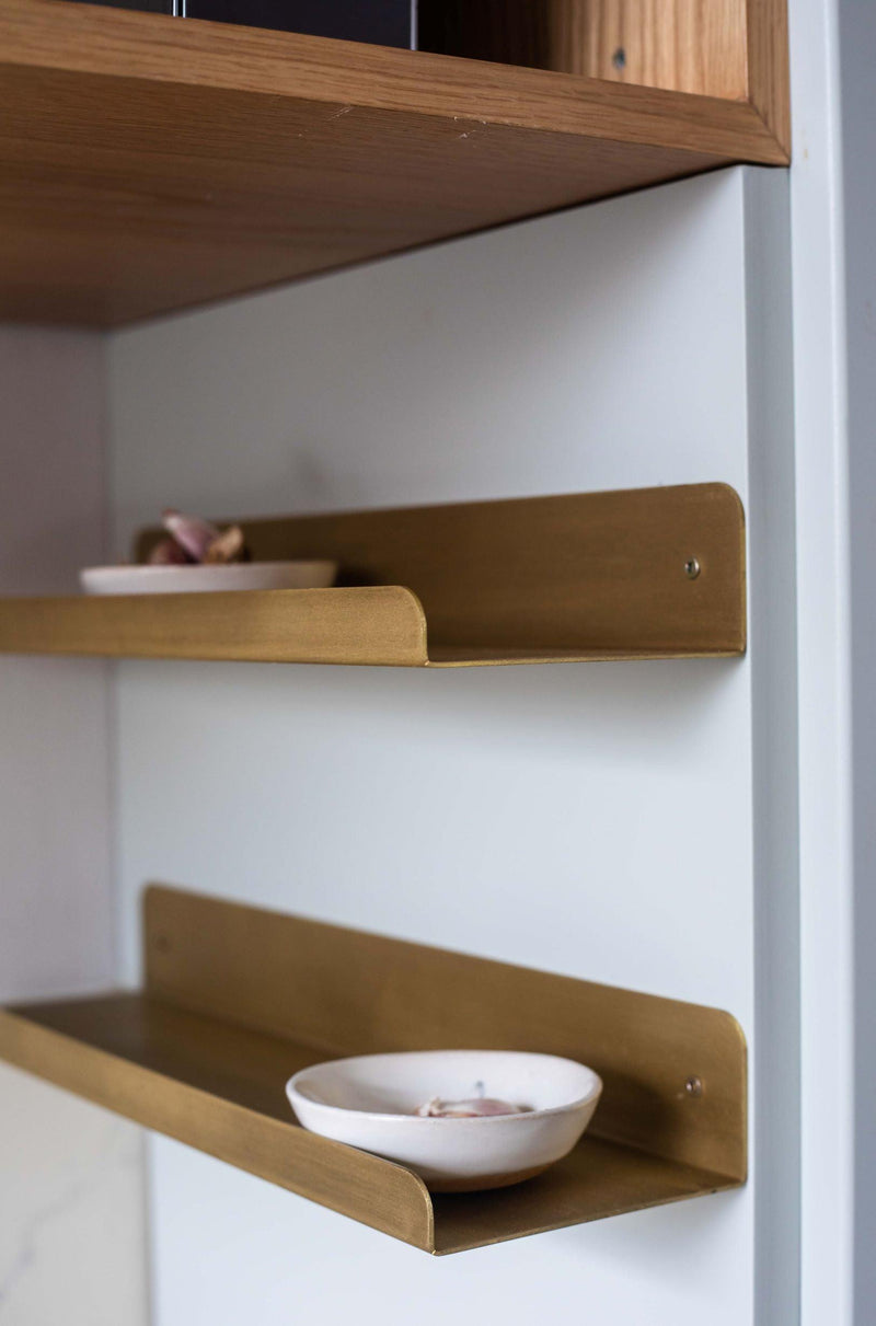 Solid brass wall shelf with a front rim